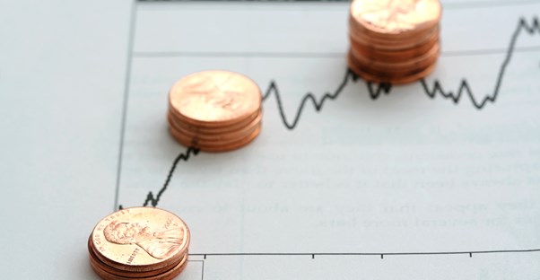 Stacks of pennies on top of a penny stock chart