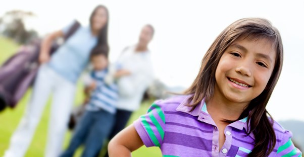 a young girl and her family enjoy a golf outing during vacation