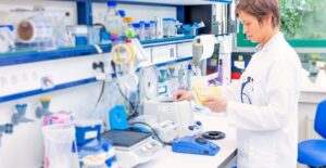 Pharmacist using her previous education to fill prescriptions