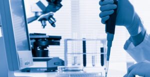 Pharmacy technician mixing together medicine