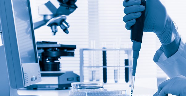 Pharmacy technician mixing together medicine