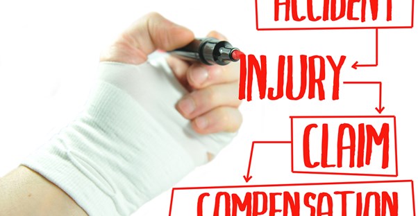 A wrist wrapped in a bandage draws a red diagram of workers compensation