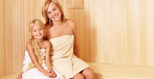 Mother and daughter wrapped in towels at a spa