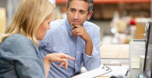 Small business owners discussing the benefits out inventory management software.