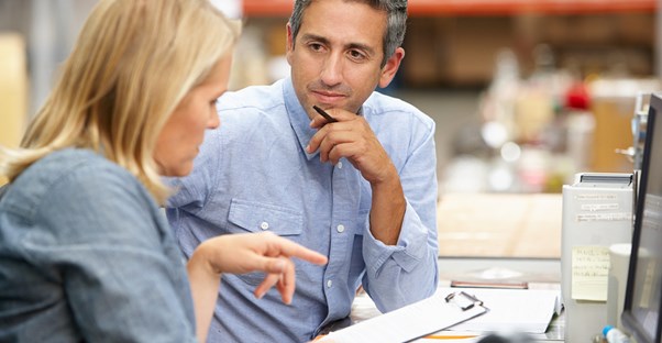 Small business owners discussing the benefits out inventory management software.