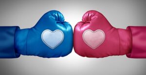 a male (blue) and female (pink) boxing glove with hearts on each fist bump in a sign of mutual respect