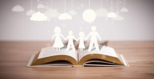 a paper family emerges from the pages of a book