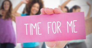a woman holds a card that says time for me