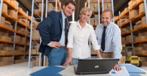 Business associates smile because they chose the right inventory management software for their business