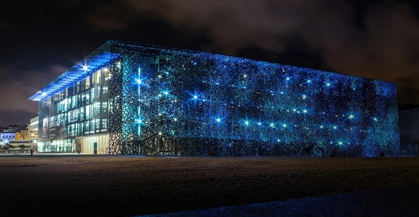 an ai data center lit up in blue lights at night