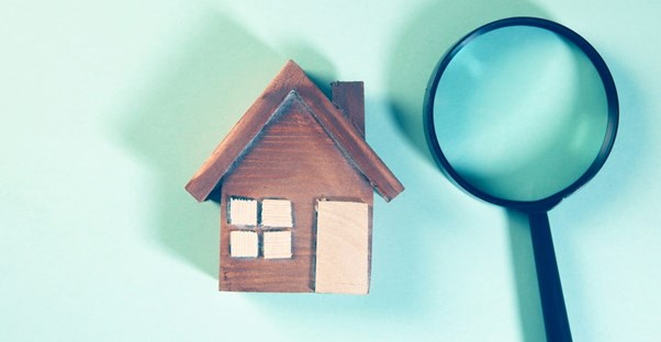 a house and a magnifying glass symbolizing a not very well known mortage clause