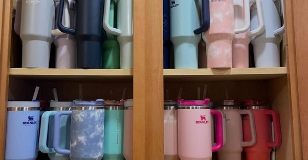 a collection of colorful stanley cups