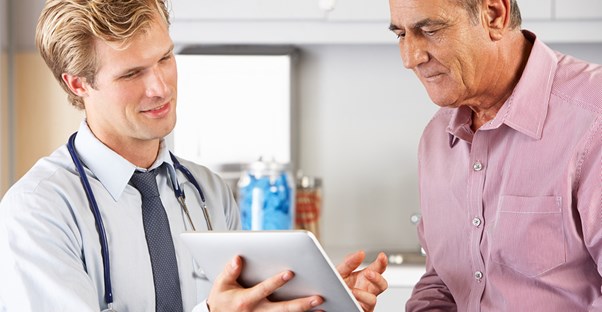 a doctor explaining how electronic medical records improve a patients' care