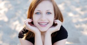 a girl working to get used to her braces
