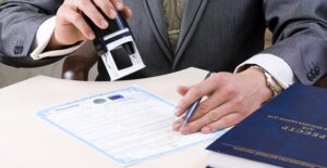 Man stamping a certificate of deposit agreement after the investor has managed his account and decided to get a new interest rate.
