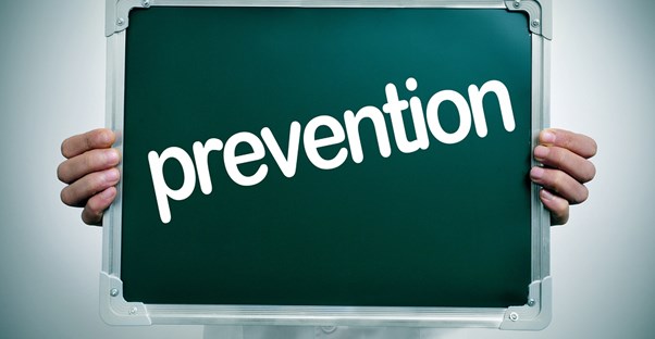 a doctor who is talking to a patient about how to prevent gynecomastia causes