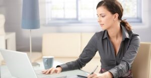 Woman researches potential graphic design careers as she gets ready to graduate with a graphic design degree.