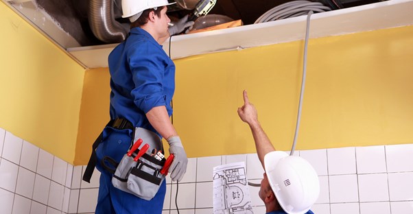 two technicians working at one of the three best HVAC jobs