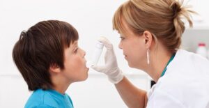 a repiratory therapist performs a test on an child