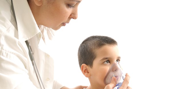 a respiratory therapist gives a young patient an exam