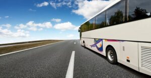 a tour bus barrels down the highway to its next destination