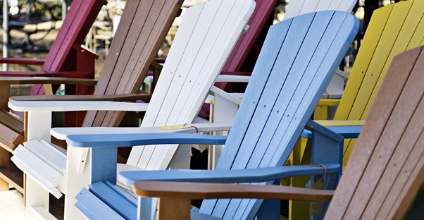 colorful adirondack chairs sit facing the Gulf of Mexico in Sanibel Island, Florida