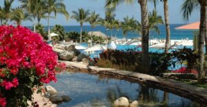 a pool and resort complex alongside the ocean in Cabo San Lucas