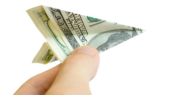 a $100 bill is folded into the shape of a paper airplane