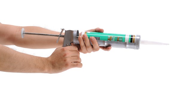a caulking gun at the ready for an eminating craft