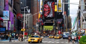 a taxi drives through Times Square new york city