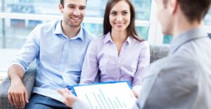 A couple talks to an adviser about the signs they believe mean they need a home loan.