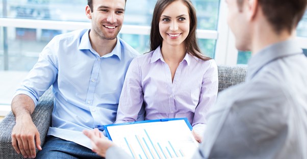 A couple talks to an adviser about the signs they believe mean they need a home loan.