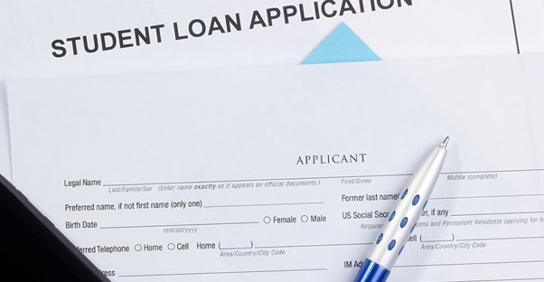 A student loan application sits on a table waiting to be filled out by a student looking for financial aid.
