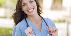 A nurse practitioner student smiles knowing she will be a great nurse practitioner.