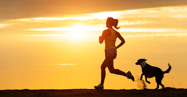 a woman edges out her four-legged friend to win a foot race