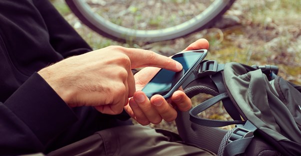 a guy plays with his GPS on his phone
