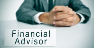 A financial adviser sitting at a desk as he explains what he can do for his clients.