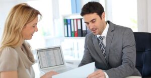 A woman speaking to a potential financial adviser about her future goals.