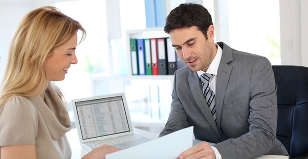 A woman speaking to a potential financial adviser about her future goals.