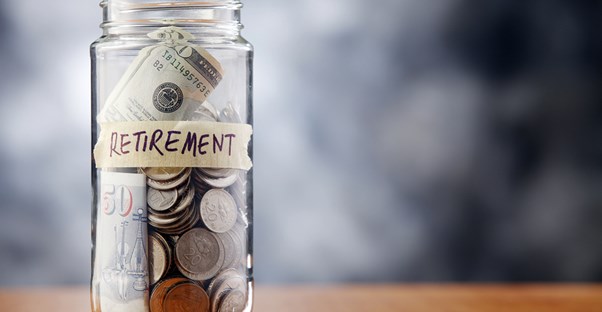 A jar labeled RETIREMENT holding spare change to represent a reason you need a financial adviser.