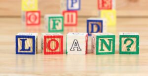 Blocks spelling out LOANS? to represent the types of college loans.