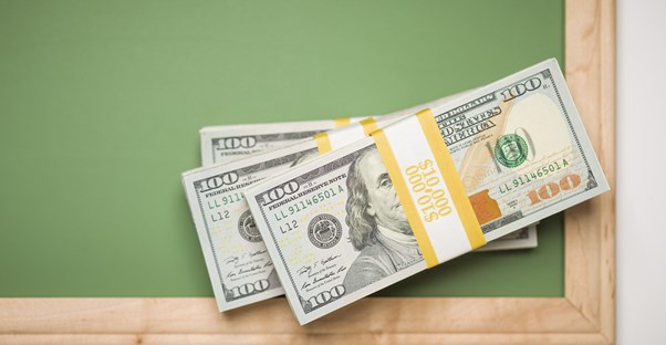 A stack of money a college student had to pay back on a college loan.