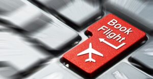 a computer keyboard with a button that says book flight