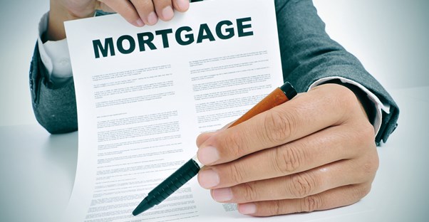 A lender offering a home loan agreement to a potential client.
