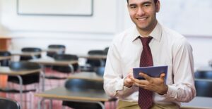 a teacher uses his tablet in his classroom