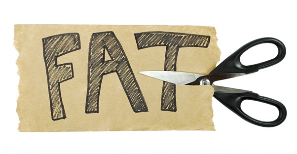 scissors cutting a piece of paper that says fat