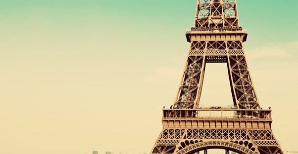 the eiffel tower stands in the distance