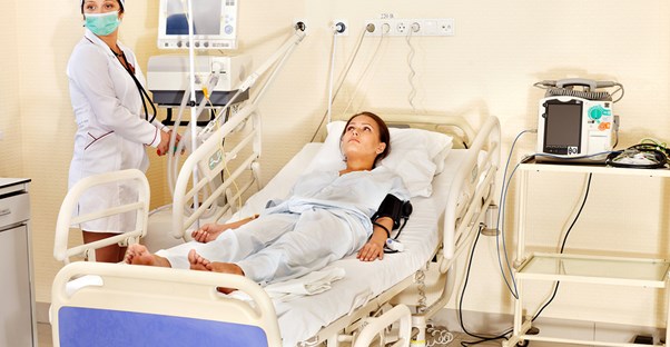 a doctor inserting a women's catheter