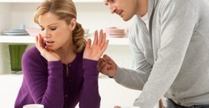 A man and woman in a disagreement that signals they need couple's therapy.