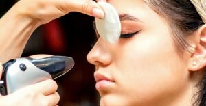 a woman's makeup is airbrushed on